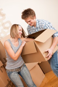 1606900-new-house-young-couple-moving-box-unpacking